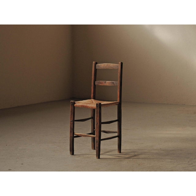 Simple and sturdy folk chair dating from around 1900, with a solid wood frame and a traditionally woven rush seat,...
