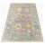 This traditional handwoven Turkish rug features a recreated antique Oushak design. The elegant purple field contains a...