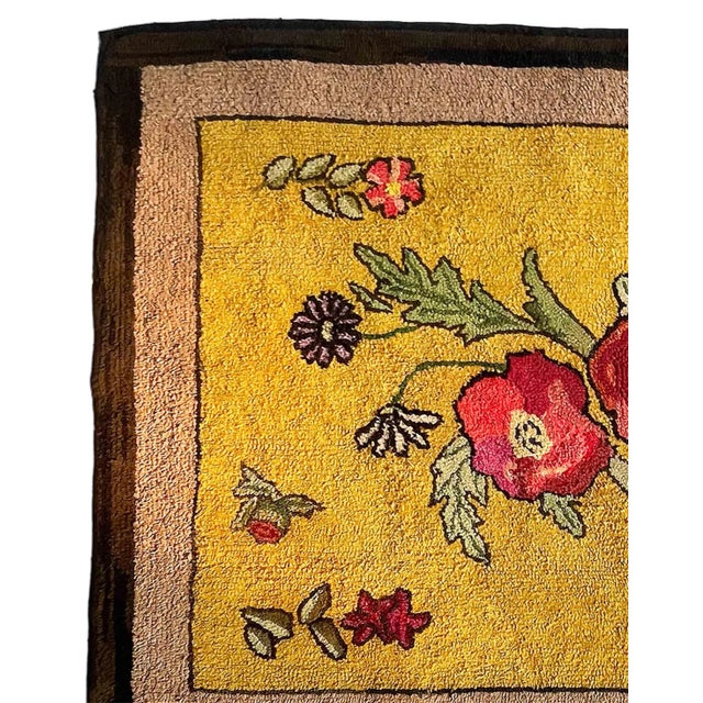 Antique American Folk Art hooked rug featuring a vibrant floral design on a mustard-yellow field. Hand-hooked from wool...