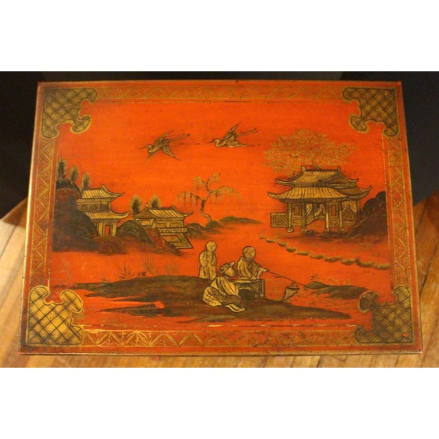 Edwardian, circa 1900, set of 4 red lacquer nesting tables, English. Parcel gilt accents throughout each chinoiserie scene...