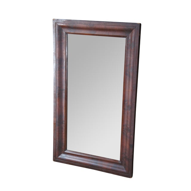 A very large and impressive antique American Empire wall vanity mirror, made of flamed mahogany featuring rectangular form...