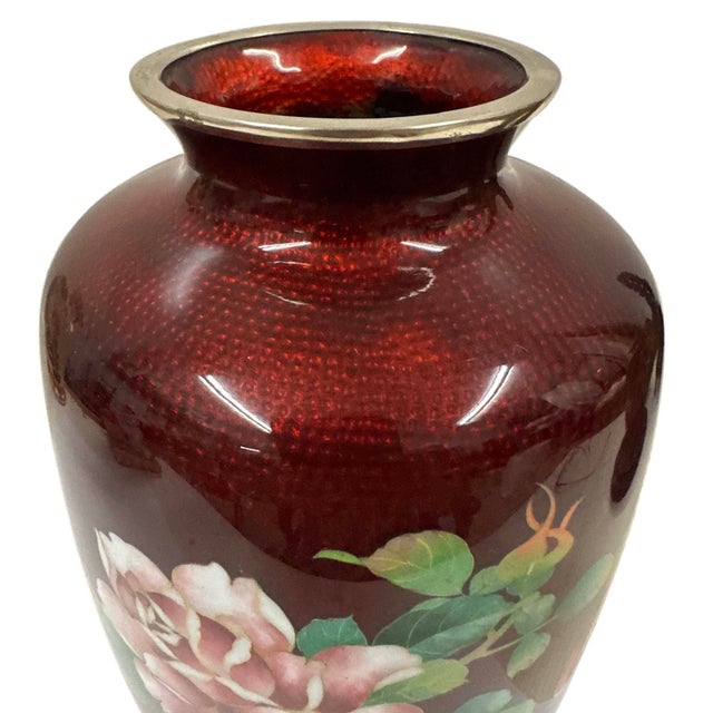 This item is a vintage Japanese cloisonné enamel vase featuring a distinctive semi-translucent pigeon blood red ground. It...