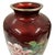 This item is a vintage Japanese cloisonné enamel vase featuring a distinctive semi-translucent pigeon blood red ground. It...