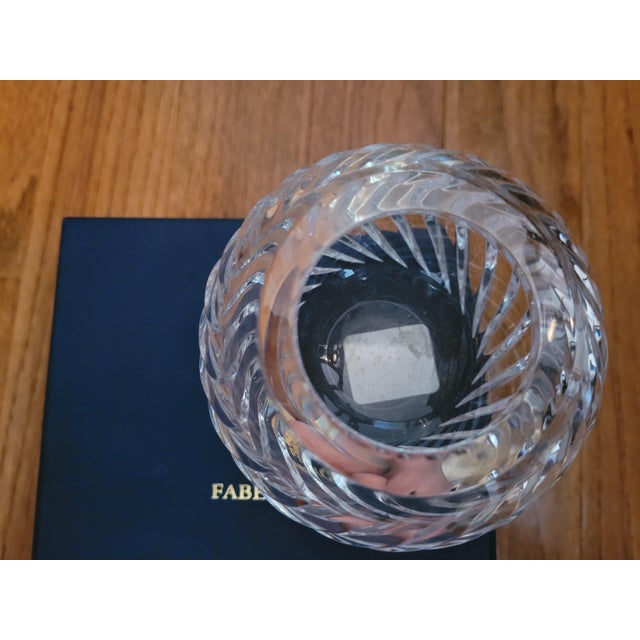 Enhance your decor with this beautiful candleholder from Faberge. This crystal votive holder is made of crystal clear...
