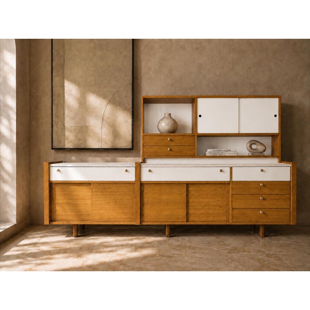 Attributed to Martin Borenstein for Brown Saltman, this walnut modular wall unit dates to the 1960s and exemplifies the...