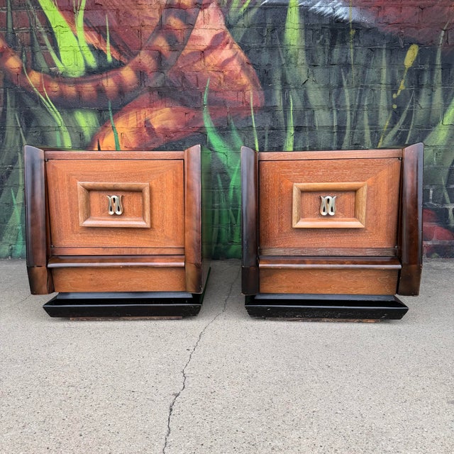 This is a pair of James Mont style stands originally made by Hellum Furniture Company. They each feature a large cabinet...