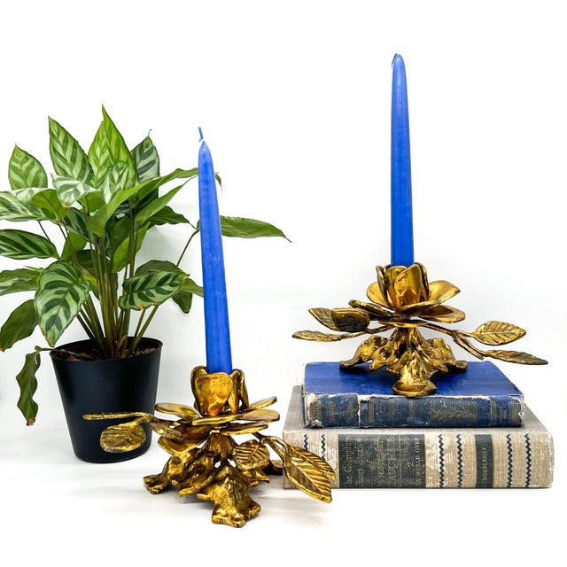 Stunning, mid-to-late 20th century pair of gold-tone metal candle holders designed as sculptural blooming roses with...