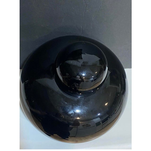 A sculptural Opachi black glass lidded vessel designed by Tobia Scarpa for Venini, Murano, Italy, circa 1979. This refined...