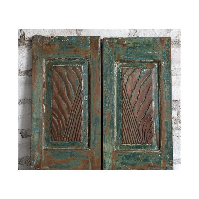 These stunning vintage double doors feature intricate blue floral carvings hand-crafted into reclaimed solid wood,...