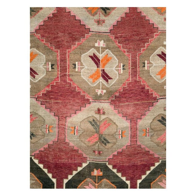 A vintage Turkish Anatolian room size rug in long and narrow gallery format handmade during the mid-20th century with a...