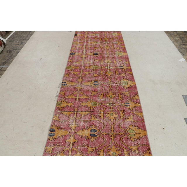 Hand knotted in Turkey originating between 1960-1970, this vintage mid-century runner joins our midcentury Pasha...