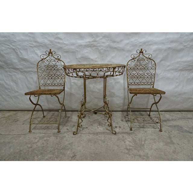 This is a hand made wrought iron Table and chairs in Original finish. Table 29 h x 28 diameter