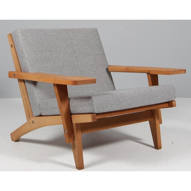 Hans j. Wegner lounge chair with loose cushions new upholstered with hallingdal wool from kvadrat frame of oak. With...