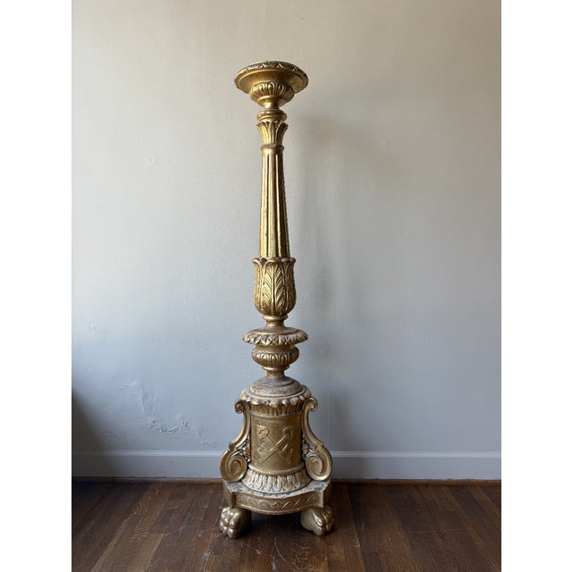 An Antique European oak candlestick, circa 1880, combines the strength of oak with a luxurious gilded finish, this piece...