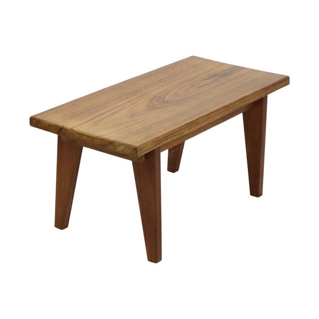 Solid teak side table or plant stand featuring a rectangular top and splayed legs; a vintage piece from the 1960s. Unlike...