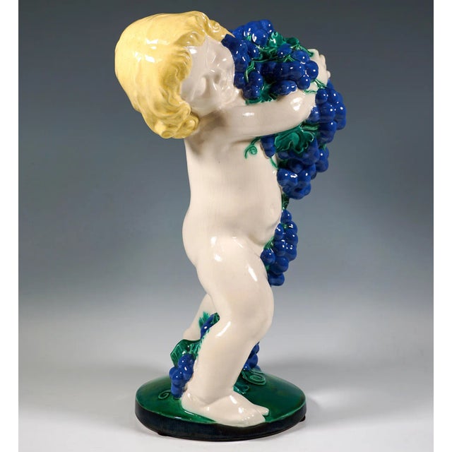 Excellent and rare art nouveau ceramic piece from a series of the four seasons: naked putto in a wide striding position,...