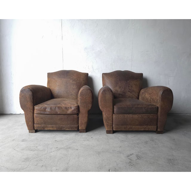 A beautiful pair of properly patinaed leather club chairs by Restoration Hardware. This pair is the epitome of perfect...