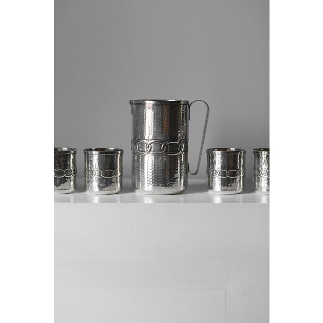 Set of 8 glasses + 1 pitcher by argentieri fratelli calegaro, 1968 product details made of silver with a hammered body and...