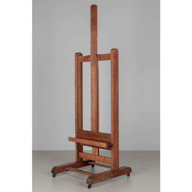 An early 20th century French painter's easel made of solid oak with ledge to hold the canvas. Adjustable, with simple...