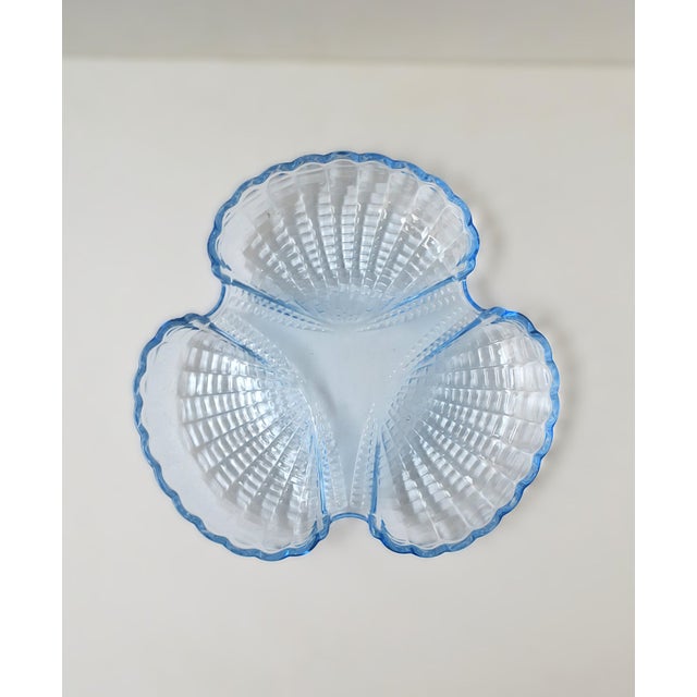 A glass scallop seashell dish with three (3) wells, circa mid to late-20th century. A great dish for entertaining. Dish is...
