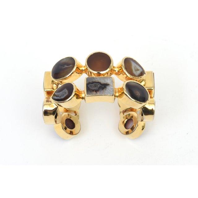 This stunning 1990's gold plated or 18K gold electroplated cuff bracelet has 2 rows of agate stones in various tonal...