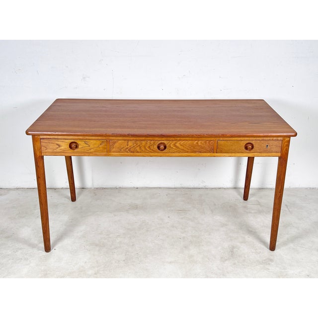 Danish three drawer writers desk in teak and oak, model AT 305, by Hans Wegner for Andreas Tuck, circa 1950s.