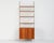 "String" bookcase in teak and lacquered metal with a suspended cabinet with sliding doors and adjustable shelves. String...