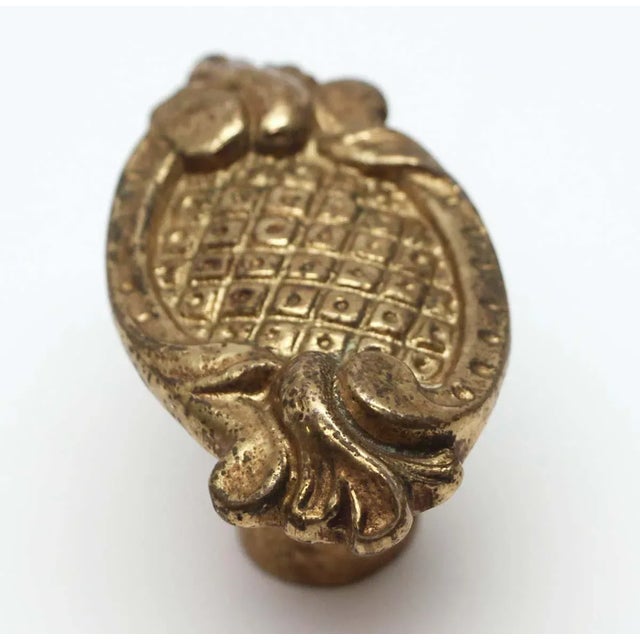 Art Nouveau oval brass doorknob with decorative details and a gilded finish. Good condition with appropriate wear from...