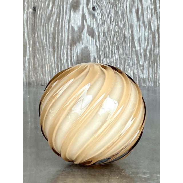 Bring glamour and artisanal elegance to your space with this stunning vintage Regency blown glass sphere. Swirled with...