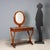 Louis Philippe dressing table in walnut veneer. Top with a recessed oval section and a tilting mirror in a removable...