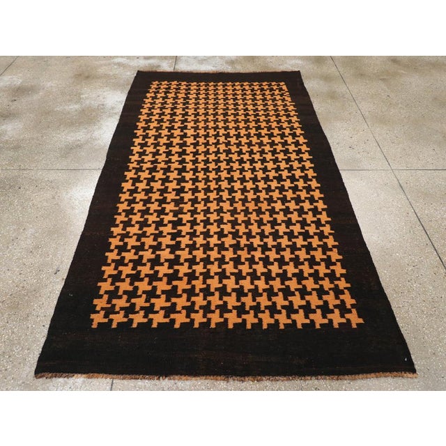 This Mid-20th century Moroccan Flatweave Kilim rug, features a bold and graphic design with a striking interplay of color...