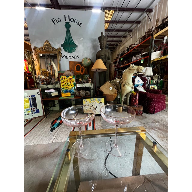 Up for consideration is a beautiful vintage pair of pink depression champagne glasses with gold rim accents. These would...