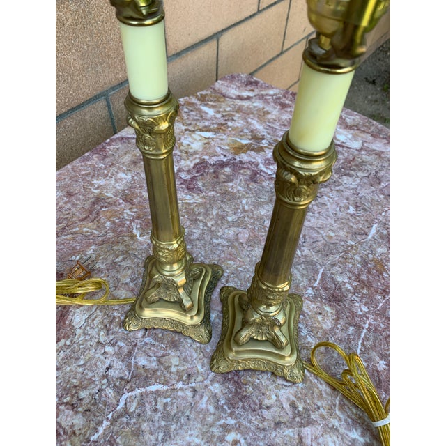 Here we have a pair of vintage solid brass French style candlestick lamps. Included with this listing are the original...