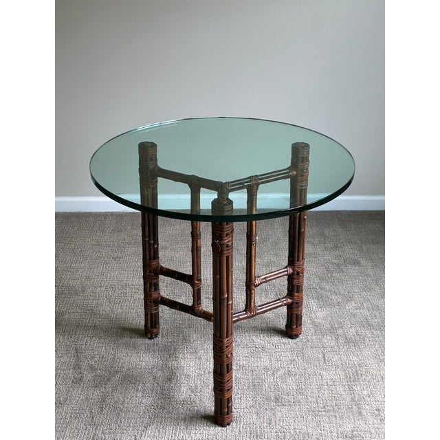 Exceptional vintage McGuire round table featuring the iconic handcrafted bamboo and rattan construction for which the...