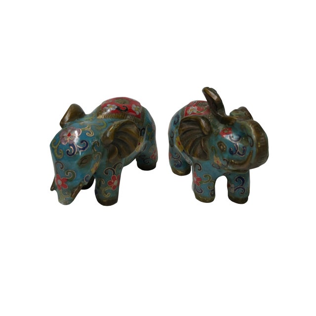 This charming pair of vintage-style cloisonné elephants stands approximately 4 inches tall, showcasing a vibrant and...