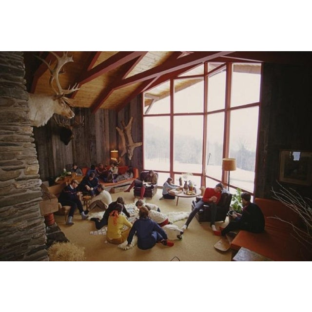 Relaxing in Lech by Slim Aarons A group of people sitting in the sun at the Gasthof Post hotel in the Austrian ski resort...