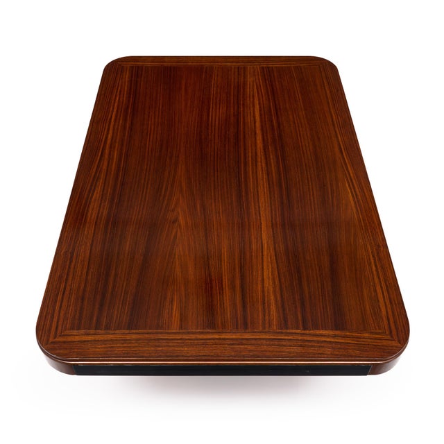 Art Deco period dining table from France. This vintage piece is made of wood construction with a beautiful rosewood veneer...