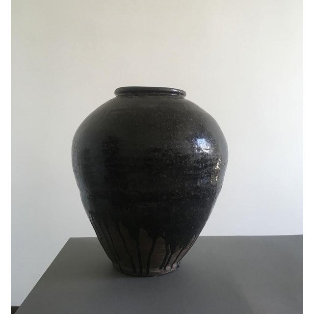 This Khmer brown glazed terracotta vase is a very stunning piece with its organic shape and all the signs of the time. The...