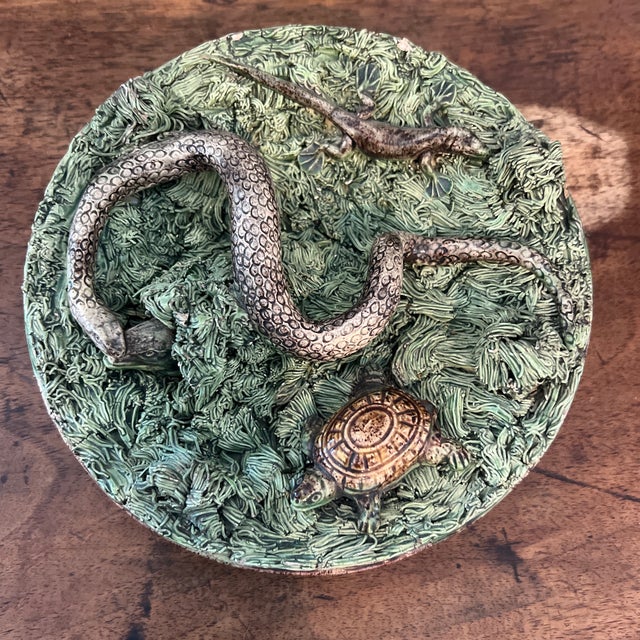 antique Portuguese Palissy-style majolica decorative plate featuring a raised relief of a snake, lizard, and turtle on a...