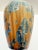 Signed studio pottery vase by Phil Morgan featuring a crystalline glaze in layered tones of amber, blue, and celadon. The...