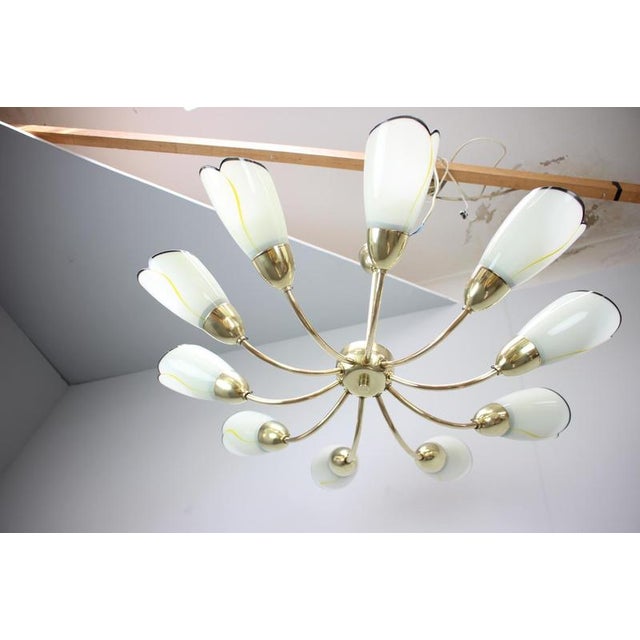 Exceptional ten-arm chandelier produced in Czechoslovakia in the 1960s. This elegant Mid-Century Modern fixture features a...
