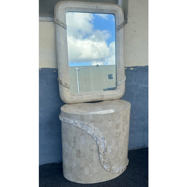 This is a postmodern tessellated travertine stone set in very good condition. The mirror dimensions are 36”H 22”W 1.5”D.