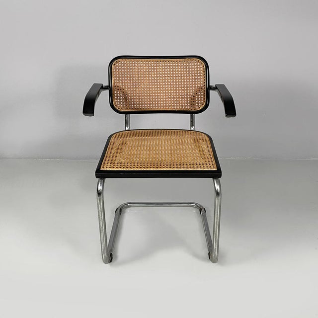 Italian mid-century modern chair with armrest in straw, black wood and steel, 1960s Chair with Vienna straw seat and...