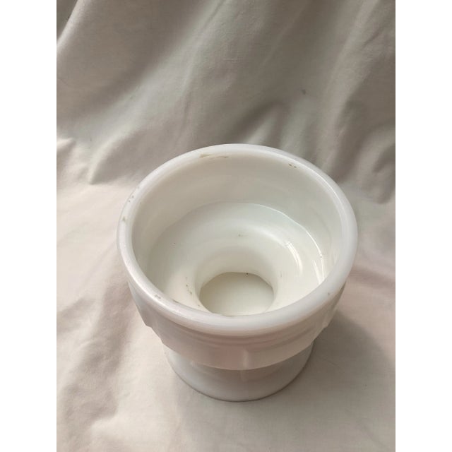 This unique milk, glass base with block motif and flared foot was likely the base for a fairy lamp, candy dish, or a...