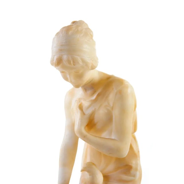 Here we have an antique Italian Art Nouveau Alabaster Sculpture depicting a Girl playing with Birds circa 1890s. The...