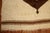 Handmade Turkish mohair rug with a chocolate brown off-center medallion on an cream colored ground. Measures: 5'2'' x 6'3''.