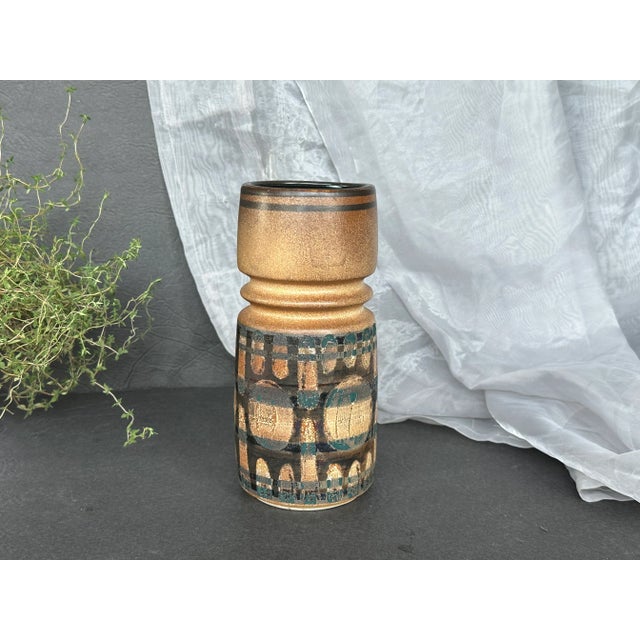 This beautiful example of studio art ceramic made by Lapid Pottery in Israel has a hand-painted mid-century modern design....