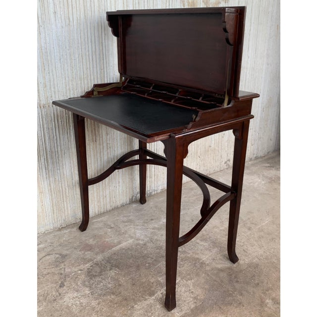 An Italian smaller-sized writing desk with storage hidden beneath top from the 19th century. This super cute desk, or...