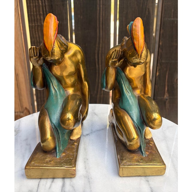 An exceptional, investment-grade matched pair of authentic 1920s Art Deco sculptural figures titled "Indian Braves...