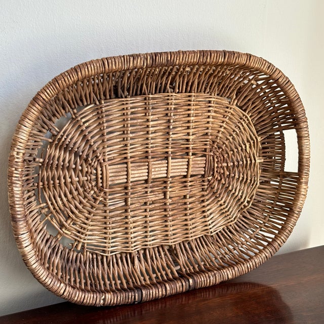 Offering a lovely Rustic European-style wicker tray with build-in handles. This pretty vintage piece from the early- to...